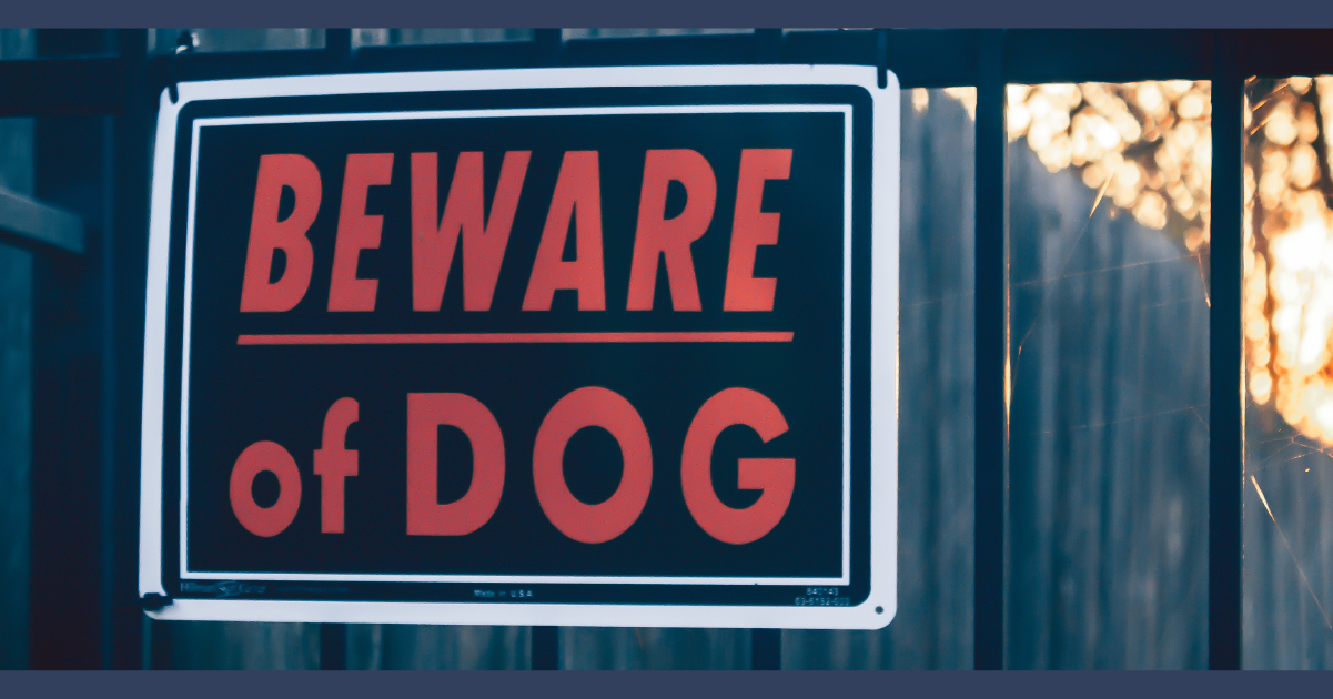 Beware of Dog sign on a wooden fence