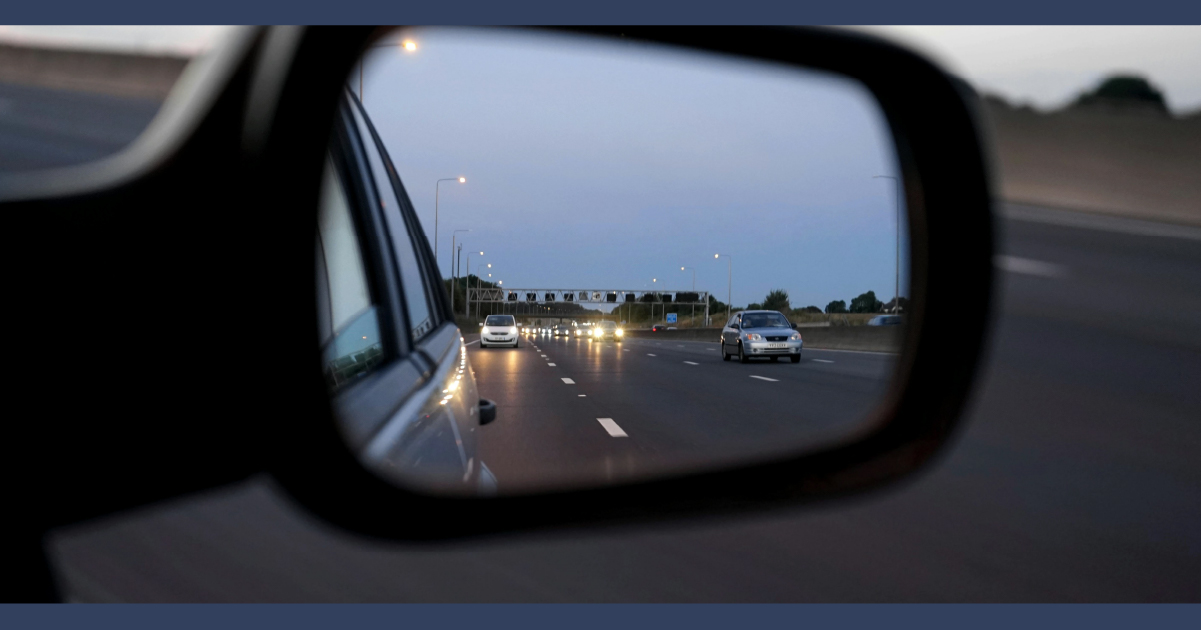 View of traffic in car wing mirror