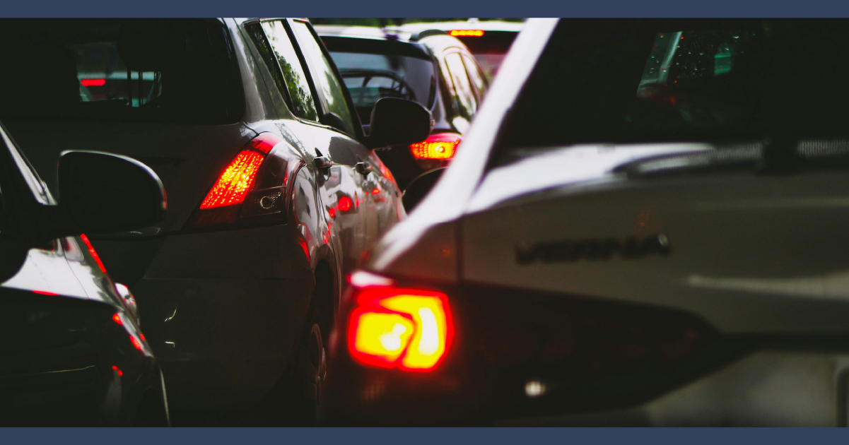 Tail lights of a car driving away in traffic