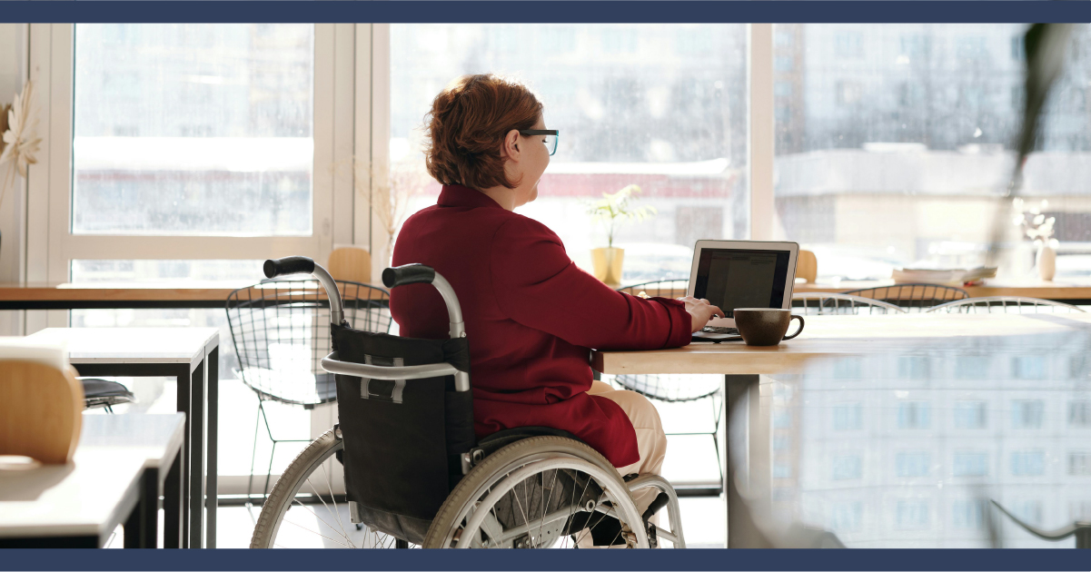 Person in wheelchair working on laptop computer