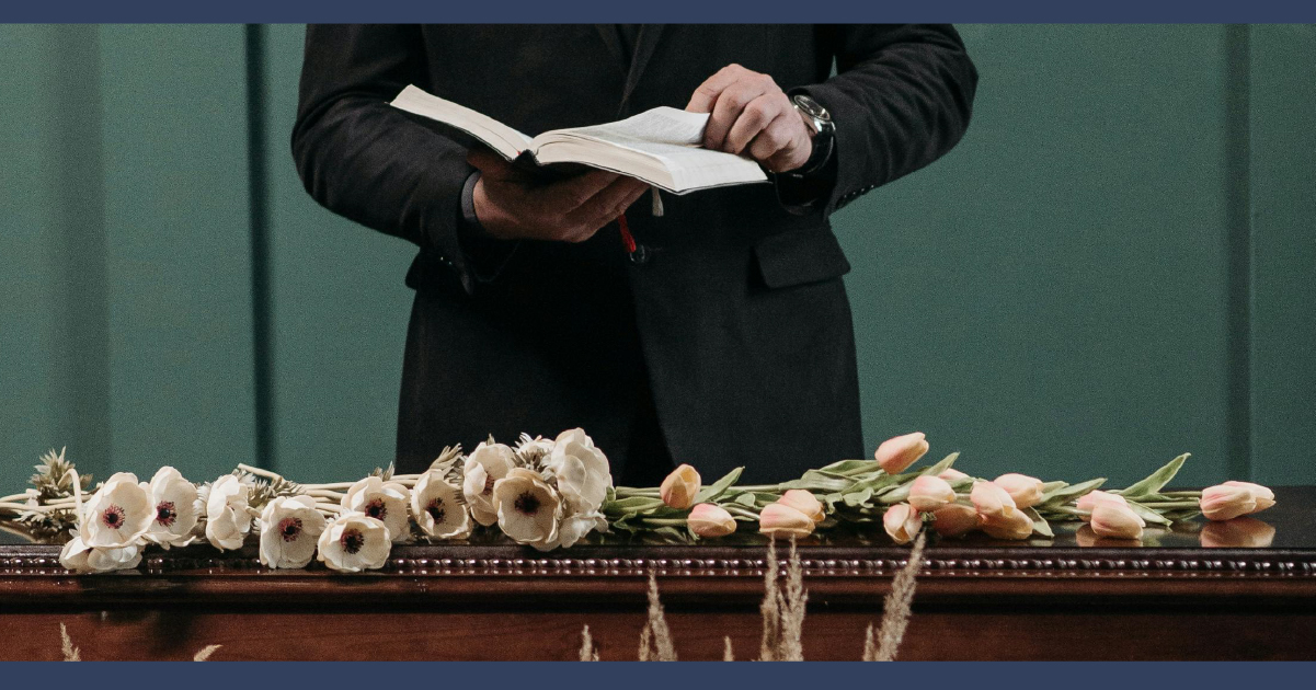 Man reading a passage form a book at a wake