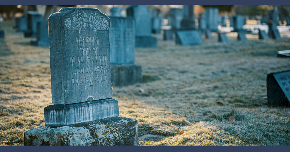 Headstone in a graveyard in the morning summer light